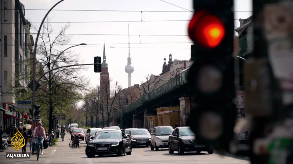 Berlin street scene with a red traffic light and the Television Tower in Al Jazeera's documentary
