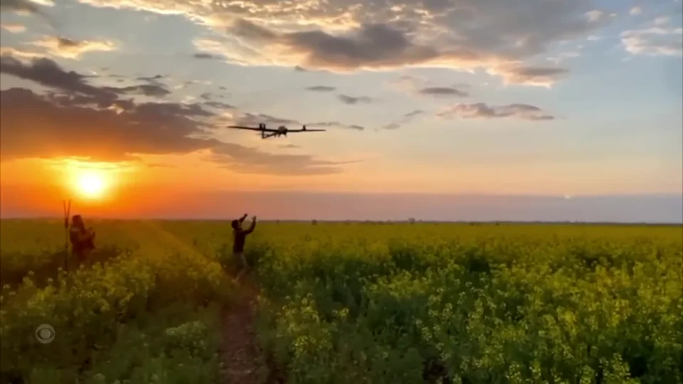 A military aircraft flying over a field at sunset in the CBS 60 Minutes documentary Germany Rearms